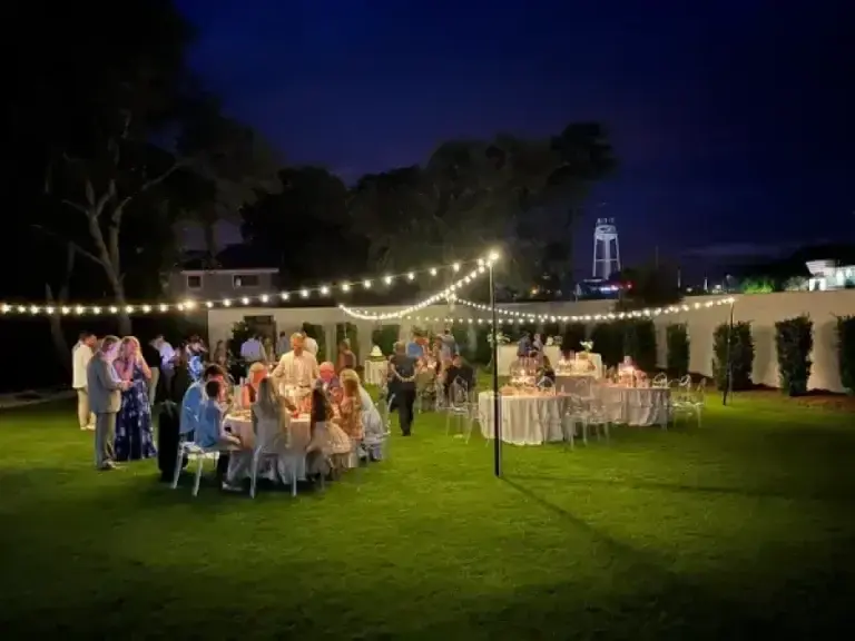 Guests gathered on the lawn during an evening reception