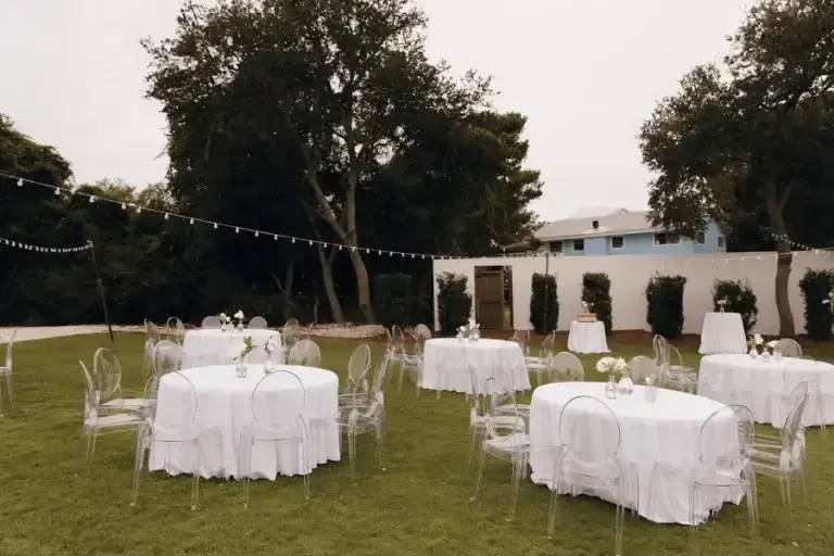 The ceremony aisle lined with white folding chairs