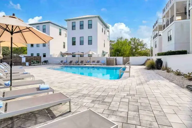 The Grove's private pool with loungers and umbrellas around the deck