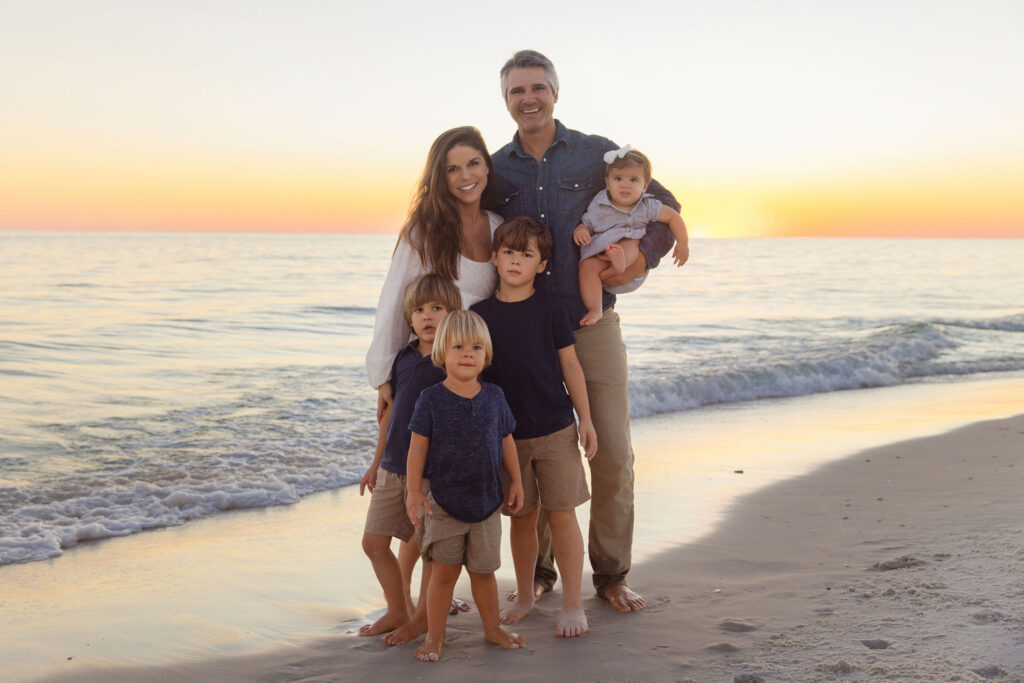candid 30A family photography session with kids playing in the sand